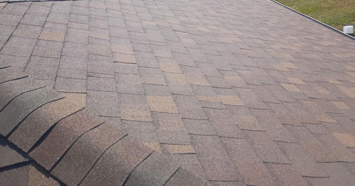 Close view of Cool Coral Canyon shingles in rose, tan and brown beside a capped hip