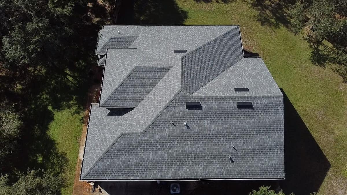 Drone view straight down on the new gray shingle roof of a one-story Eustis home