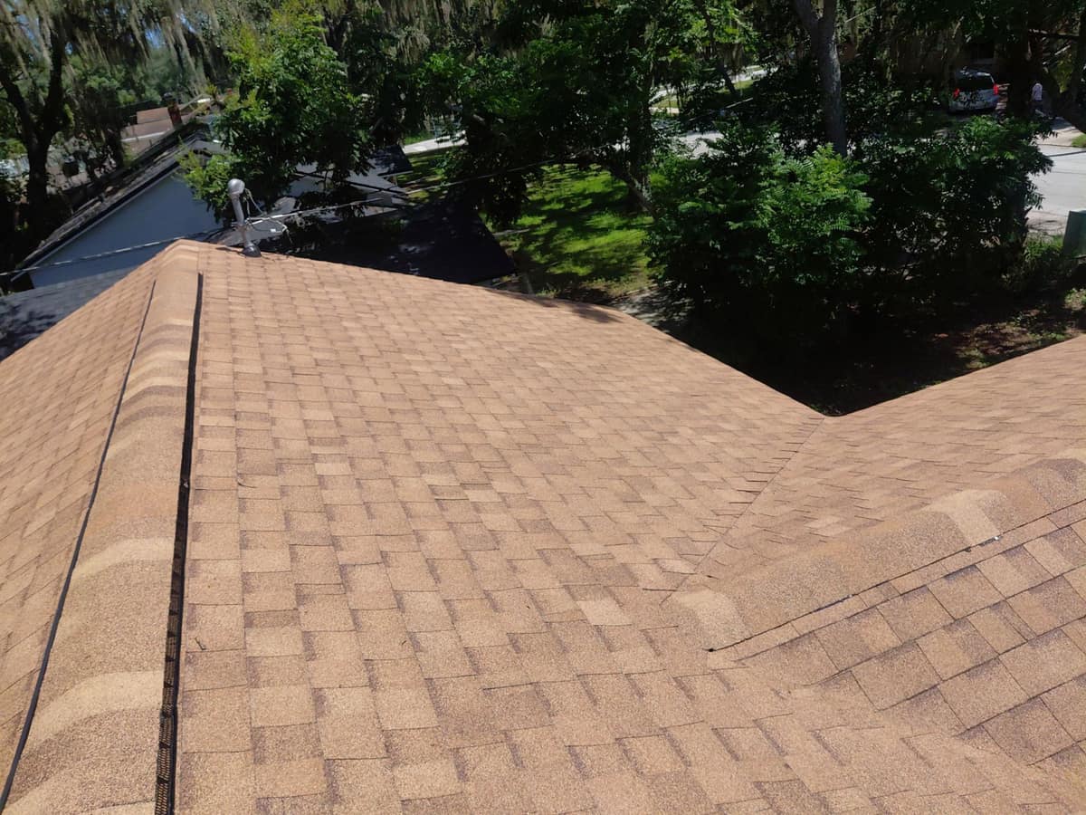 Ridge caps over a ridge vent, with a valley where a side section joins