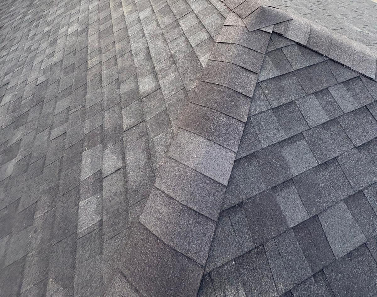 Ridge vent under the cap shingles where the hips meet the ridge
