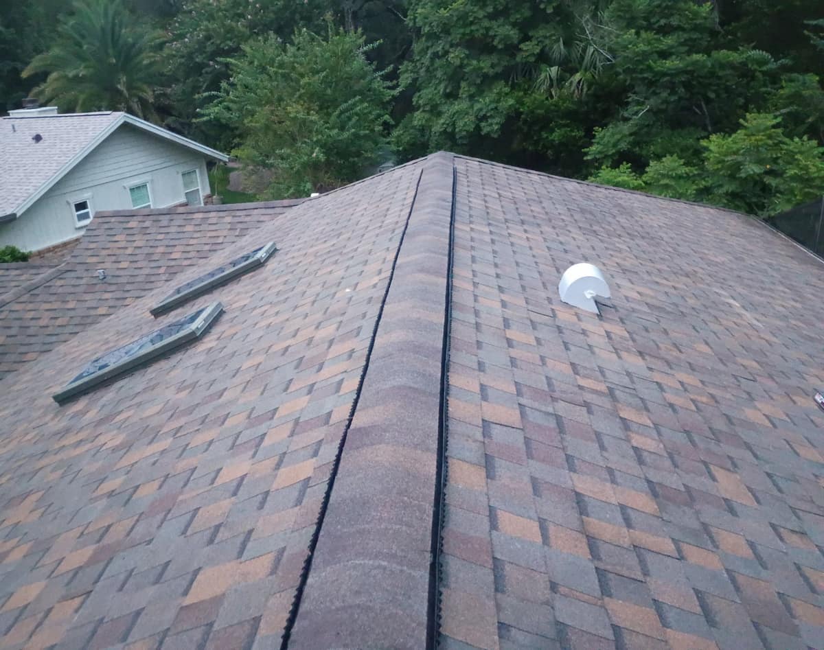 Orange City roof in Copper Canyon shingles with a vented main ridge and two skylights