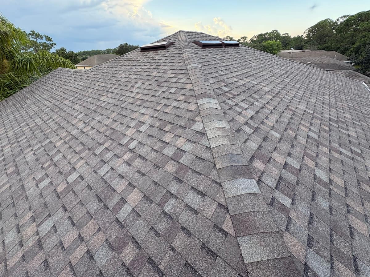 Palm Bay hip roof in TAMKO Titan XT shingles with box vents near the peak