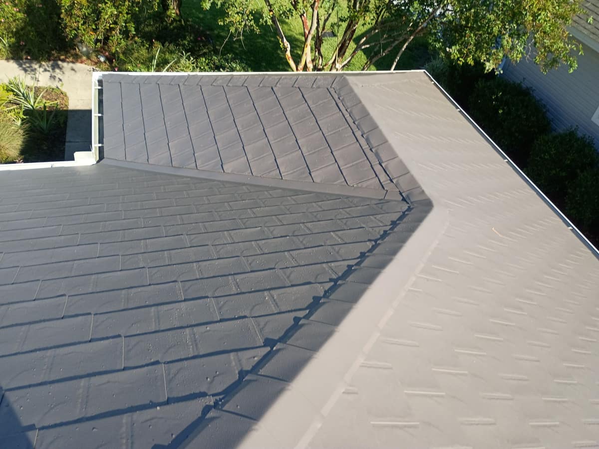 Open metal valley on a new PermaLock metal roof in The Villages, with a white gutter and crape myrtle below