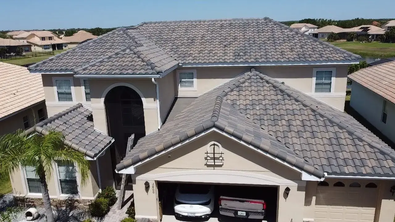 Gray tile roof on a two-story stucco home, photographed from above