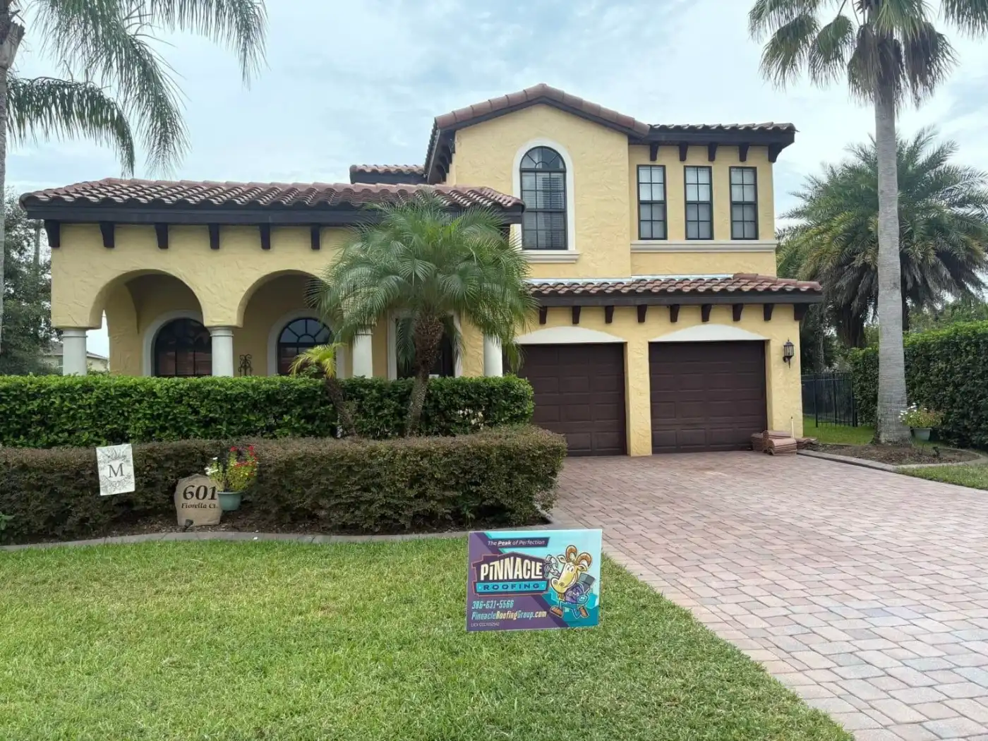 Mediterranean tile roof on a two-story home with a Pinnacle yard sign