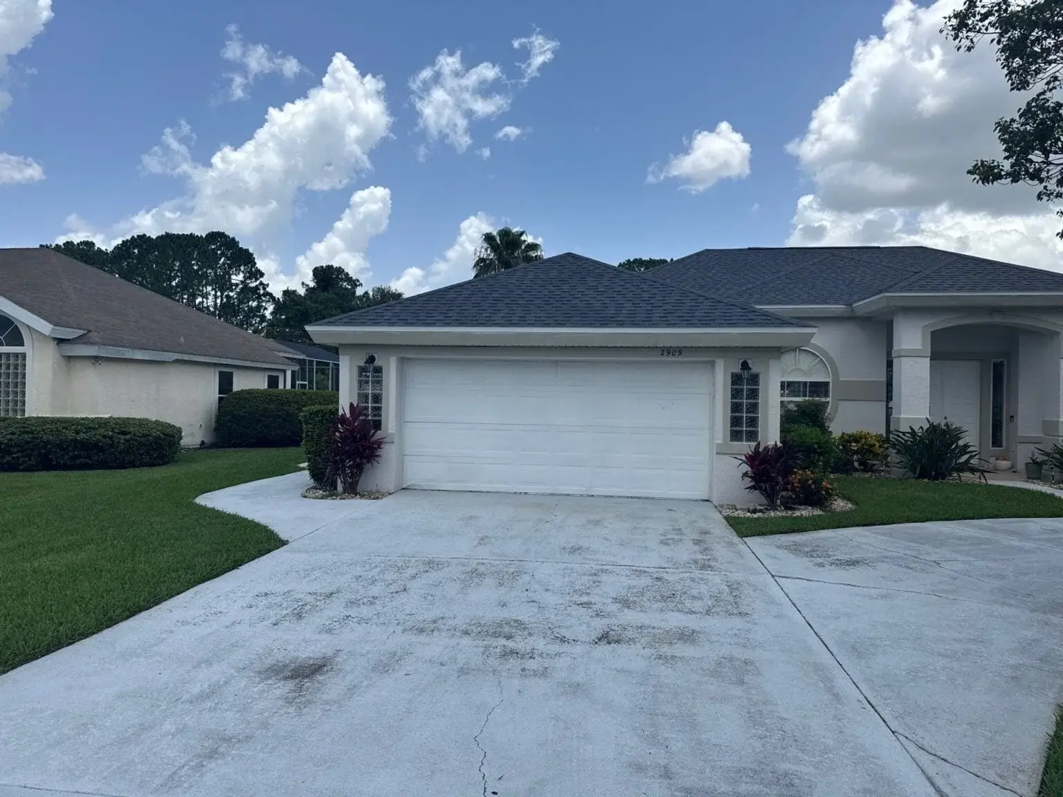 Dark shingle roof on a light stucco home