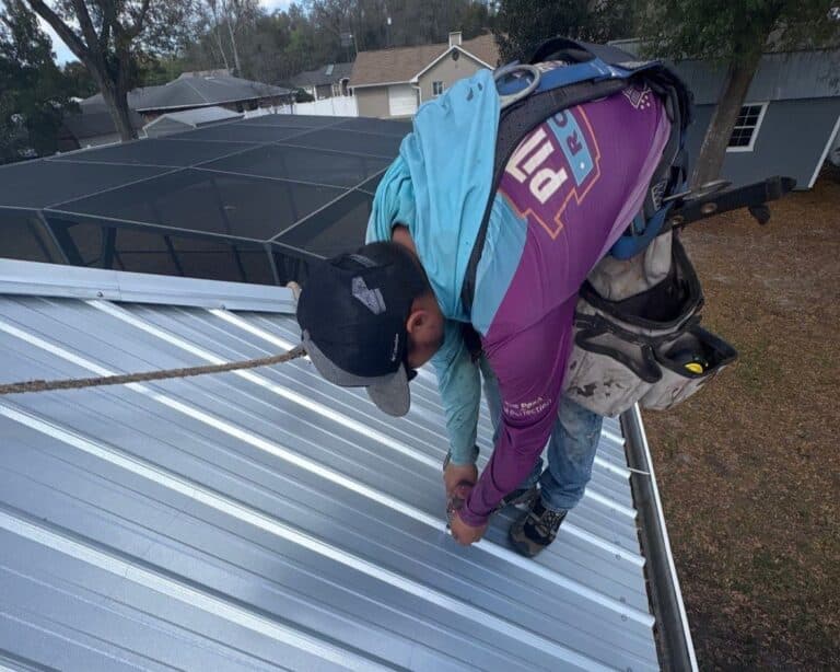 Professional roofing contractor crew performing roof replacement installation on residential home